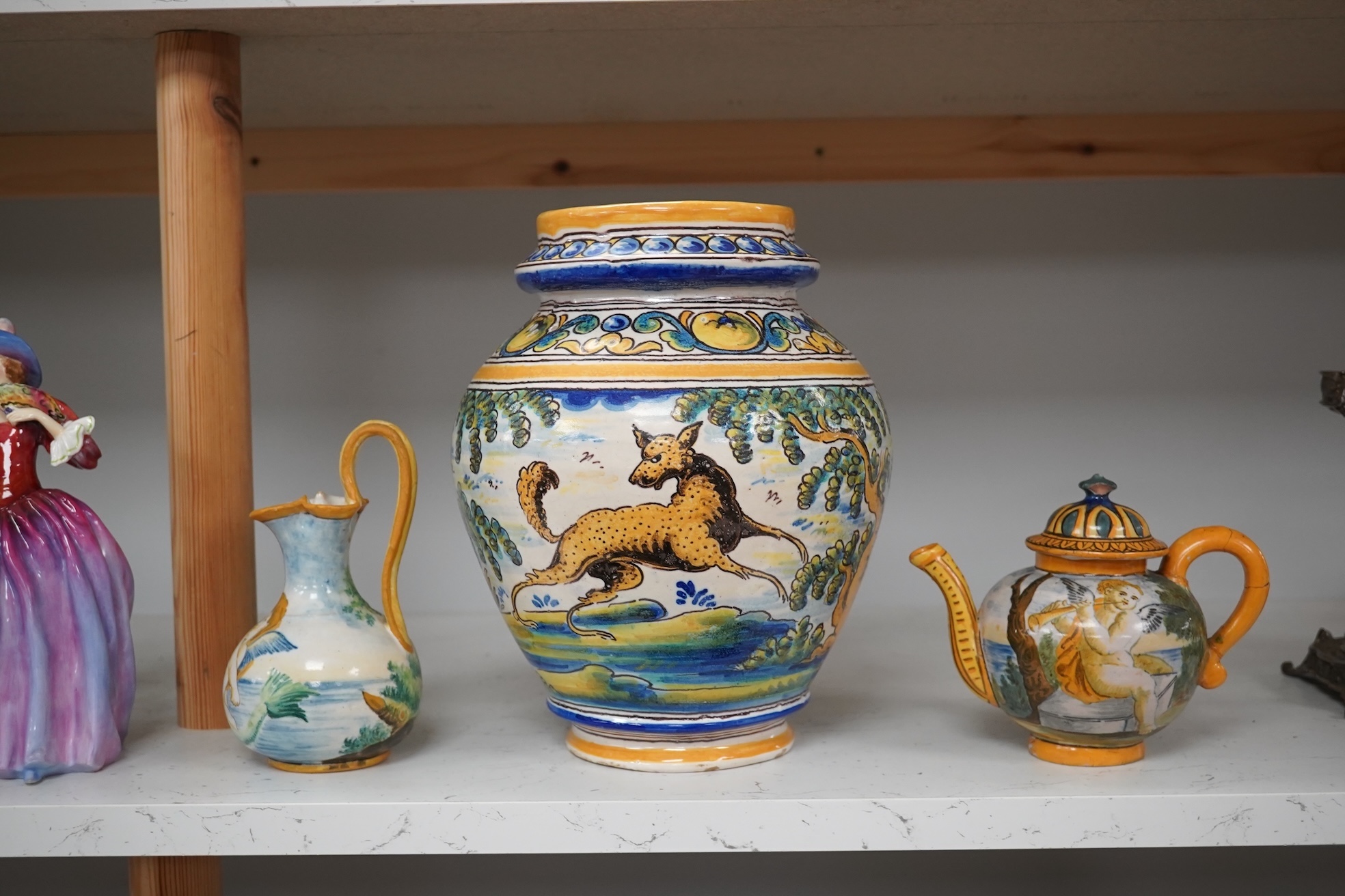 An Italian maiolica teapot and jug and a Talavera maiolica vase, 25cm high (3). Condition - jar good, teapot restored and cracked